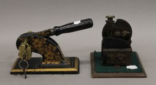 A vintage letter stamp and a pencil sharpener. The former 20 cm long.