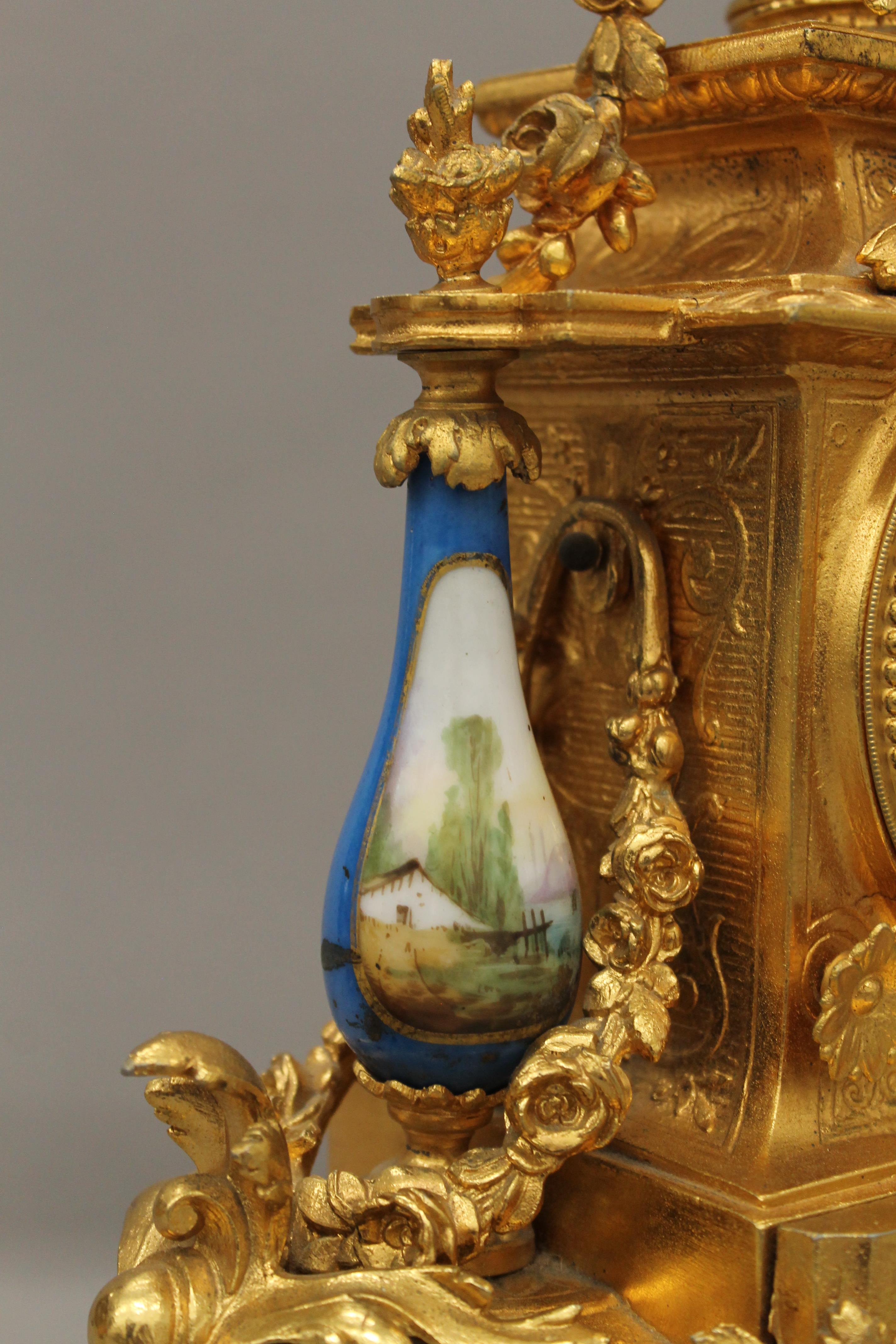 A 19th century gilt and painted porcelain three-piece clock garniture. The clock 37 cm high. - Image 5 of 11