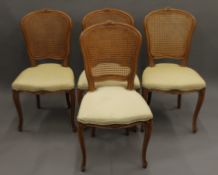 A set of four caned backed chairs.