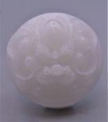 A Chinese white jade buckle. 5.5 cm diameter.