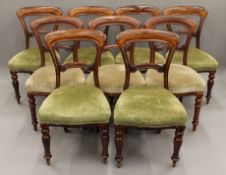 A harlequin set of eight Victorian mahogany balloon back dining chairs.