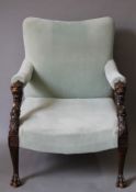 A 19th century carved mahogany upholstered open armchair, possibly Irish. 70 cm wide.