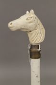 A walking stick with a porcelain horses head handle. 105 cm long.