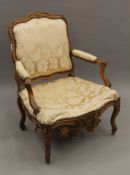 A 19th century walnut framed upholstered open armchair. 72 cm wide.