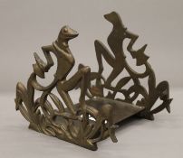 A 1940's brass Art Deco book stand formed as frogs. 18 cm wide.