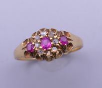 An 18 ct gold diamond and ruby ring. Ring size O.