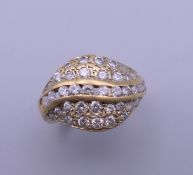 An 18 ct gold bombe cocktail ring. Ring size J. 4.8 grammes total weight.