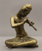 An Eastern brass figure of a musician. 22 cm high.