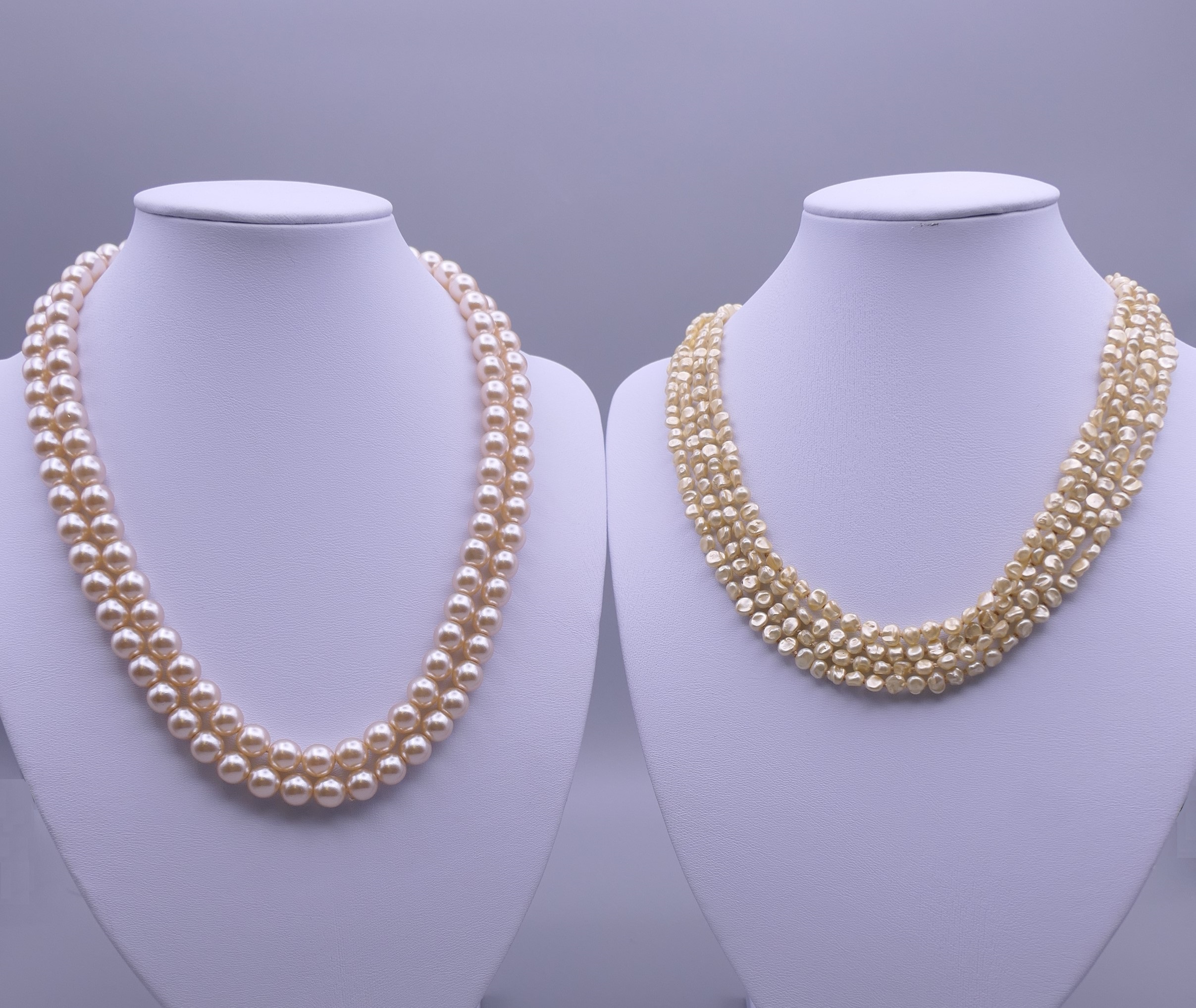 A two strand pearl necklace and a four strand pearl necklace. Each 47 cm long.