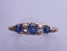 An 18 ct gold diamond and sapphire ring. Ring size O. 2.2 grammes total weight.