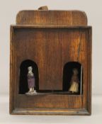 A 19th century oak Folk Art weather house. 23.5 cm high.