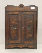 A Victorian oak smokers cabinet. 45 cm high.