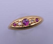 An 18 ct gold diamond and ruby ring. Ring size N. 2.1 grammes total weight.