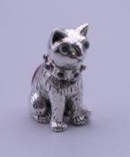 A silver pin cushion in the shape of a cat. 2.5 cm high.