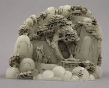 A Chinese model of a mountainous landscape. 13 cm wide.