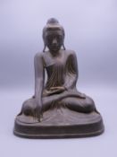 An 18th/19th century Thai bronze figure of Buddha seated in the lotus position,