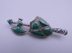 A silver malachite axe form brooch. 5.5 cm high.