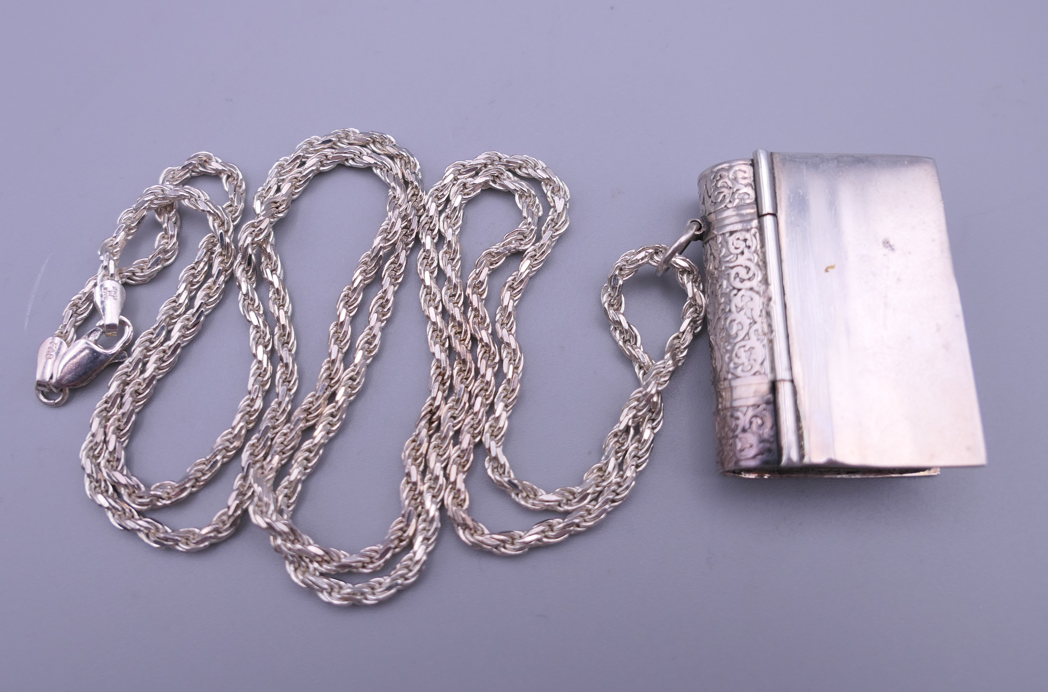 A book form pendant on chain. The pendant 3.5 cm high.