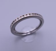 An 18 ct gold and diamond eternity ring. Ring size L. 4.8 grammes total weight.