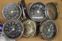 A quantity of vintage car speedometers.