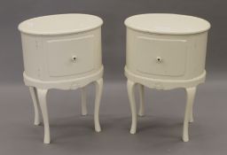 A pair of white painted oval pot cupboards. 47.5 cm wide.