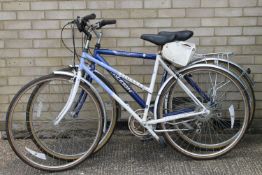 A lady's bicycle and a gentleman's bicycle.