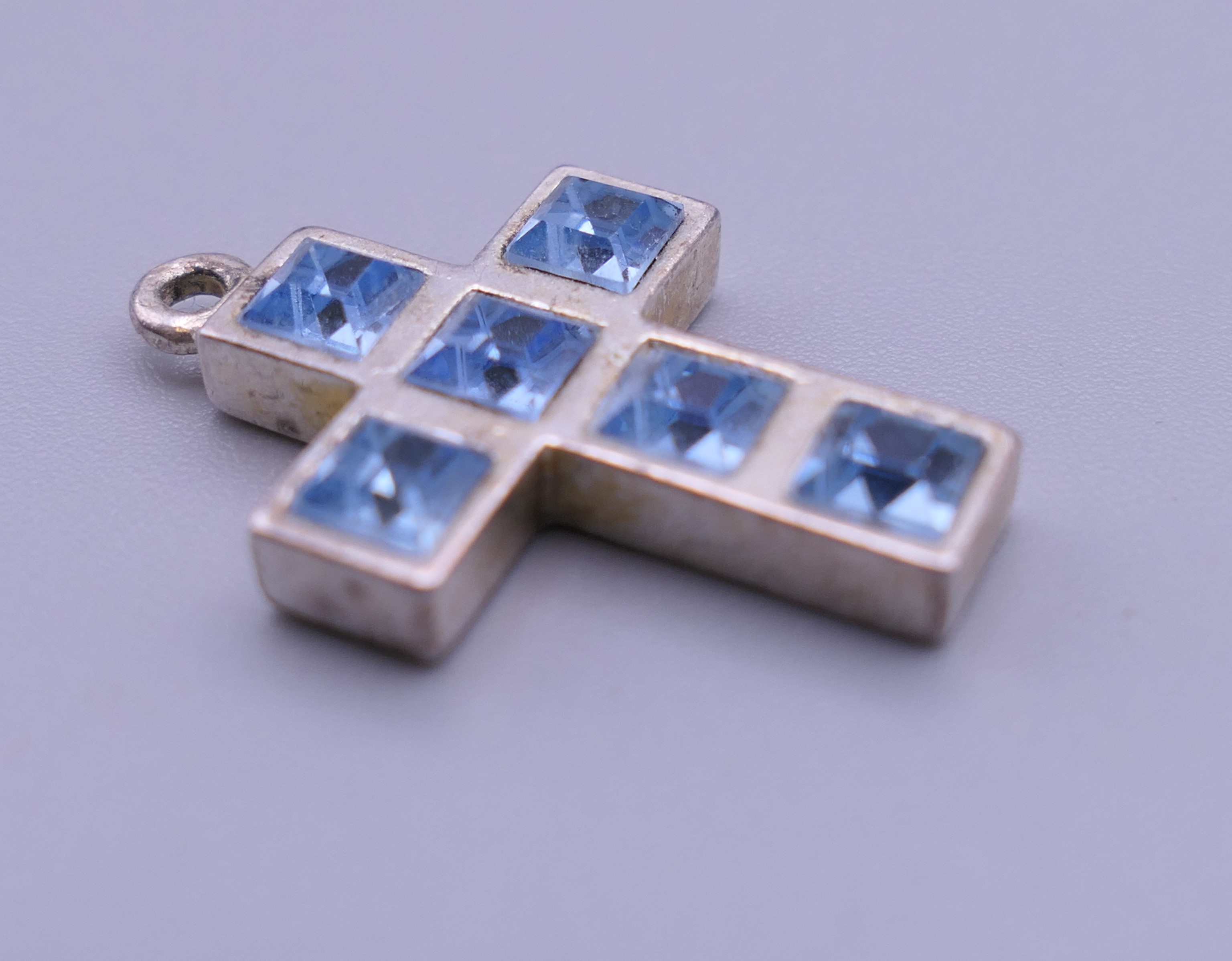 A sterling silver blue stone cross pendant, - Image 8 of 12