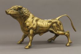 A large brass model of a bull. 45 cm long.