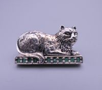 A silver cat form brooch. 3 cm wide.