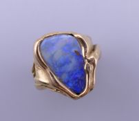 An 18 ct gold and opal ring. Ring size H/I. 10.3 grammes total weight.