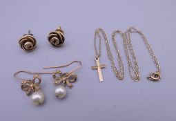 Two pairs of 9 ct gold earrings and a 9 ct gold cross on chain. 7.4 grammes total weight.