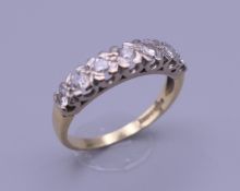 An 18 ct gold seven stone diamond ring. Ring size O. 3.2 grammes total weight.