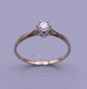 A 9 K gold 0.25 carat diamond solitaire ring. Ring size R. 1.1 grammes total weight.