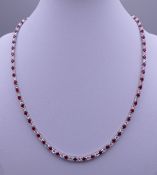 A 925 silver synthetic ruby necklace. 43 cm long.