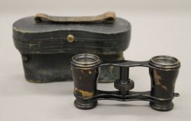 A pair of 19th century French opera glasses, cased. 11 cm wide overall.