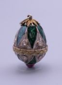 A silver enamel egg form pendant. 2.5 cm high.