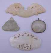 Four Chinese carved jade pendants. The largest 10.5 cm long.