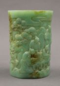 A Chinese light green carved jade brush pot. 12.5 cm high.