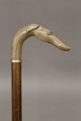 A walking stick, the handle formed as a dog's head. 91 cm long.