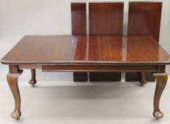 A late 19th/early 20th century extending dining table, incorporating three additional leaves,
