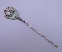 A jade mounted hair pin. 17.5 cm long.