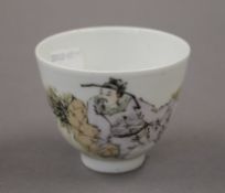 A small Chinese porcelain tea bowl decorated with a figure. 7.5 cm diameter.