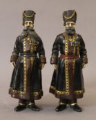 A pair of cold painted bronze models of Russians. 18 cm high.