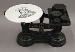 A set of Victorian grocer's scales, with ceramic plate. 35 cm wide.
