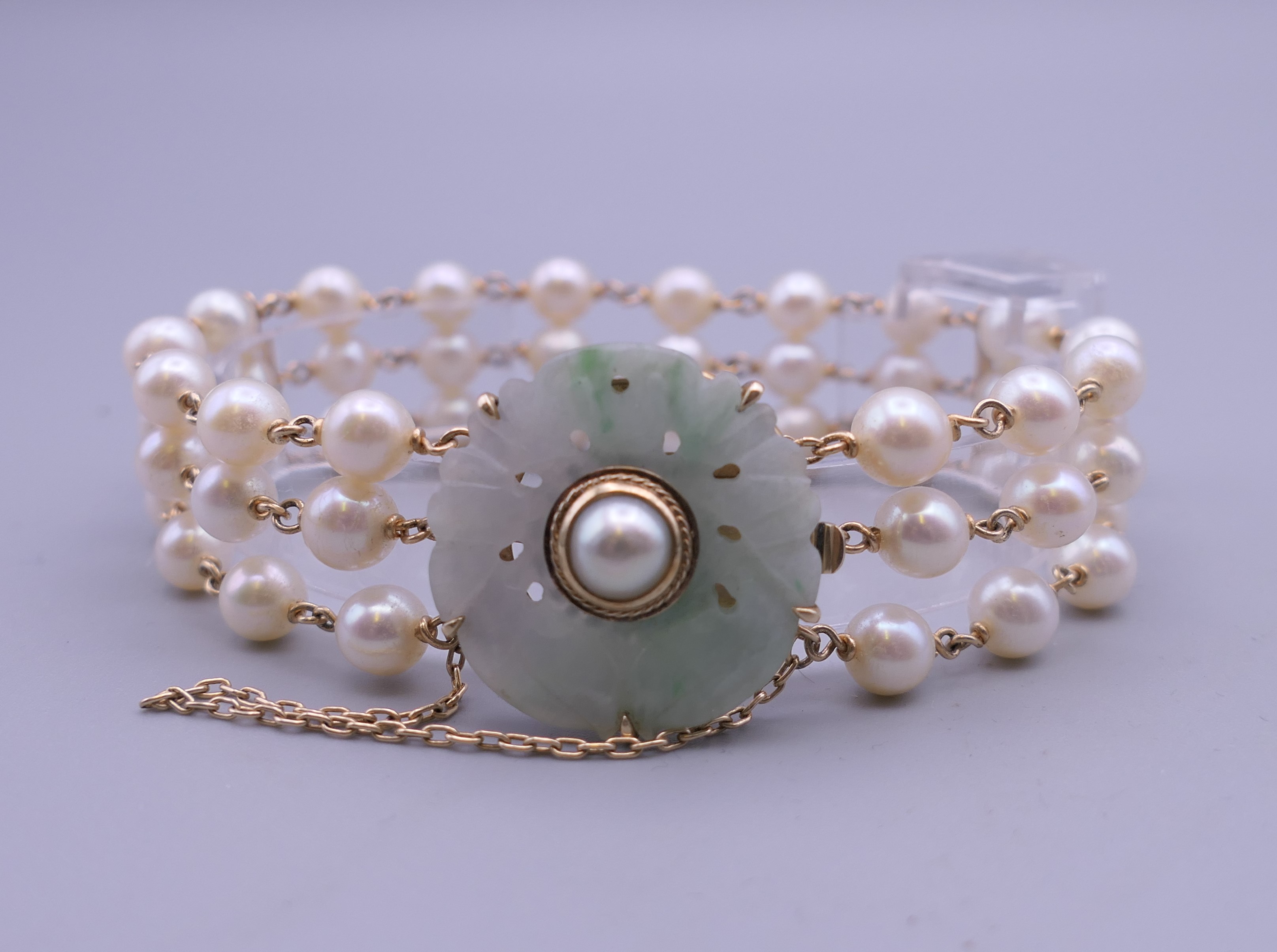 A 14 ct gold jade and pearl bracelet. 19 cm long.
