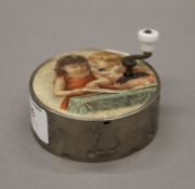 A 19th century French manneville hand crank music box. 7 cm diameter.