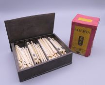 A quantity of bone hand painted Mahjong counting sticks and Thomas De La Rue Mahjong cards.