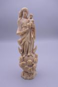 A 17th/18th century ivory figural group, formed as the Madonna and child,