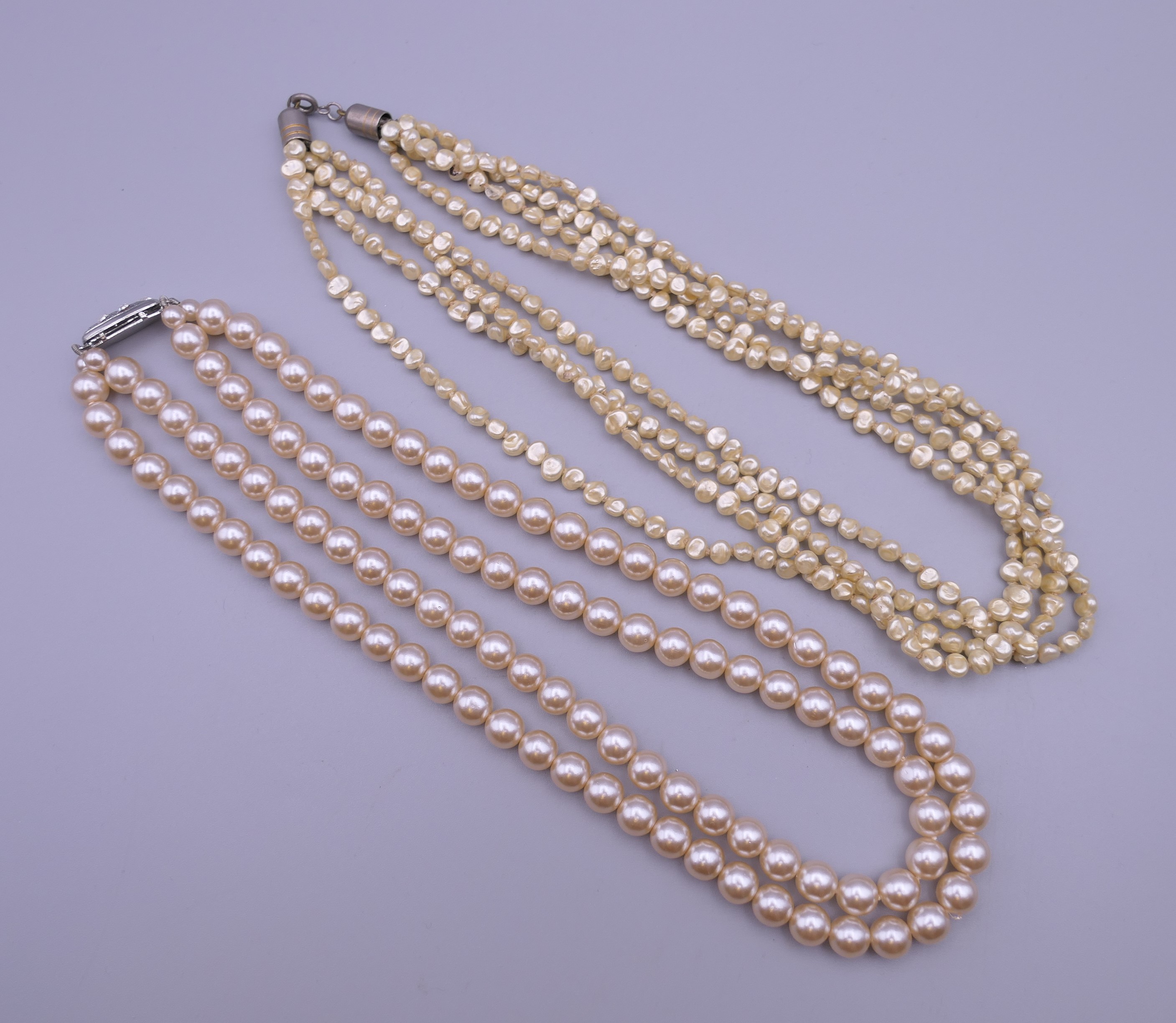 A two strand pearl necklace and a four strand pearl necklace. Each 47 cm long. - Image 5 of 9