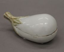 An Oriental porcelain fruit shaped box revealing a couple in an erotic pose. 10.5 cm long.